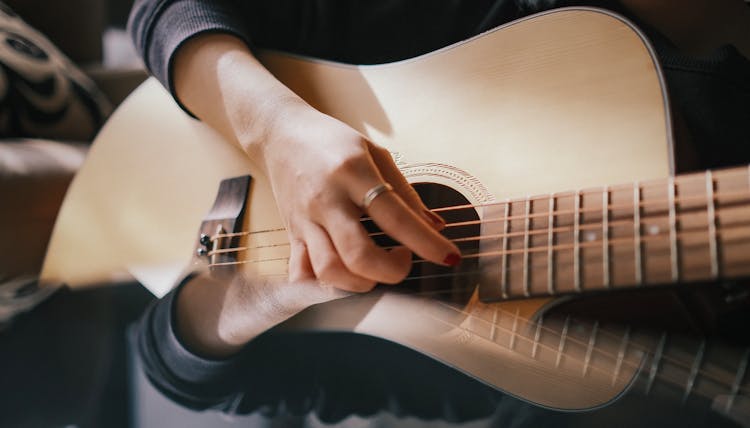 Woman Hand Playing Guitar