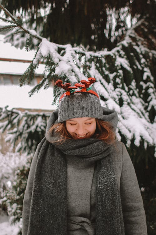 Portrait of Smiling Woman in Reindeer Antlers