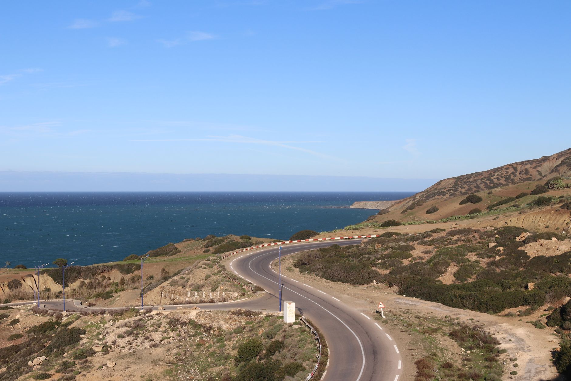 Explore the winding coastal road with ocean views in Mostaganem, Algeria.