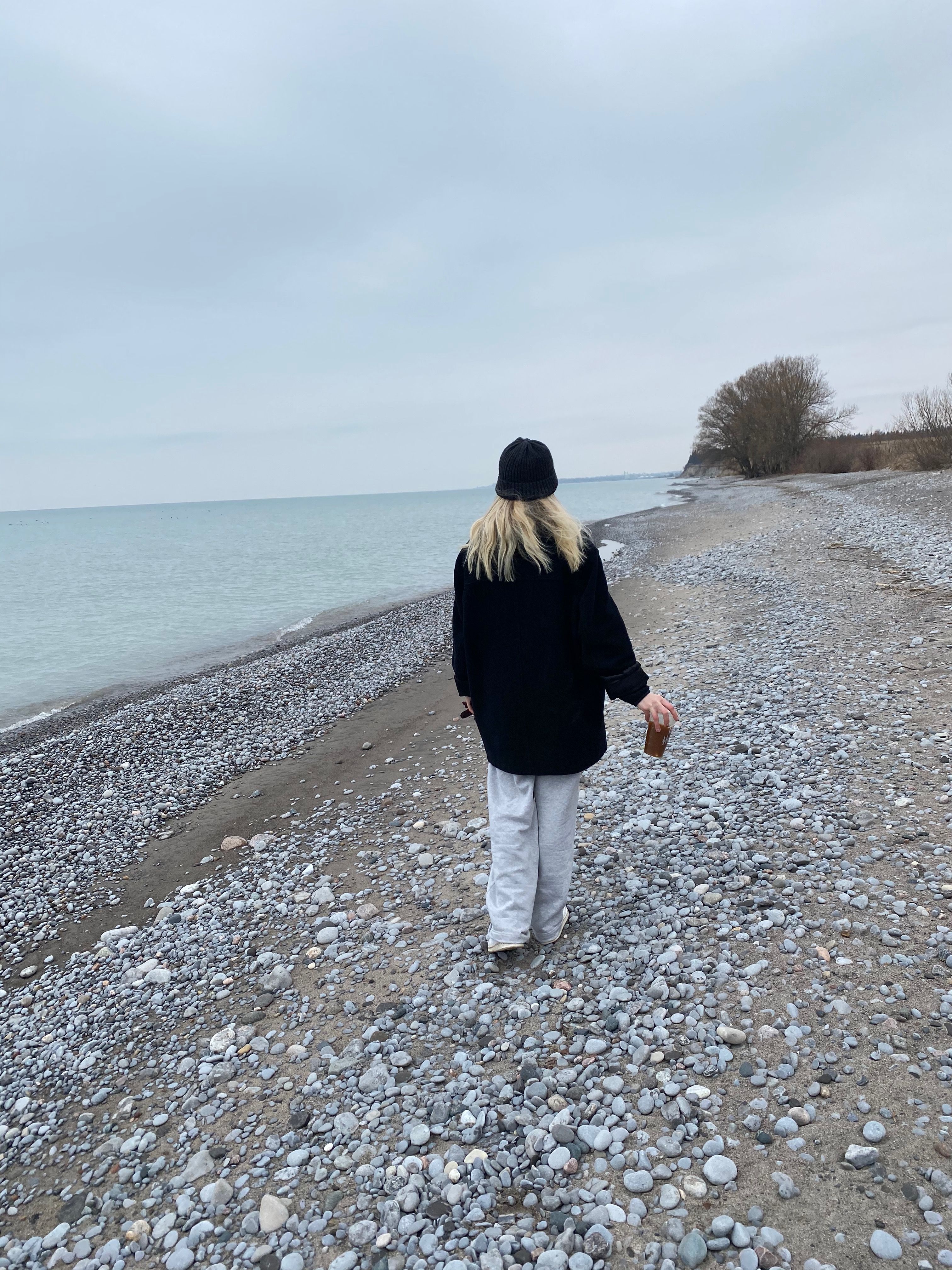 Woman in Black Jacket Walking on a Rocky Shore of a Beach · Free Stock ...