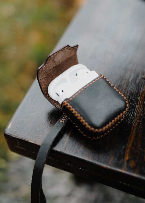 Free Close-Up Shot of Wireless Earphones on a Leather Case Stock Photo