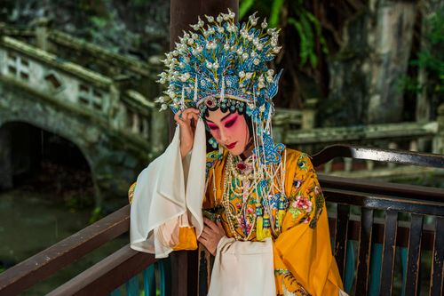 Free A woman dressed in elaborate traditional Chinese opera costume and headdress, showcasing intense makeup and ornate details. Stock Photo