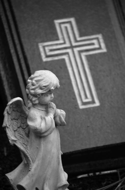 Grayscale Photo of an Angel Figurine