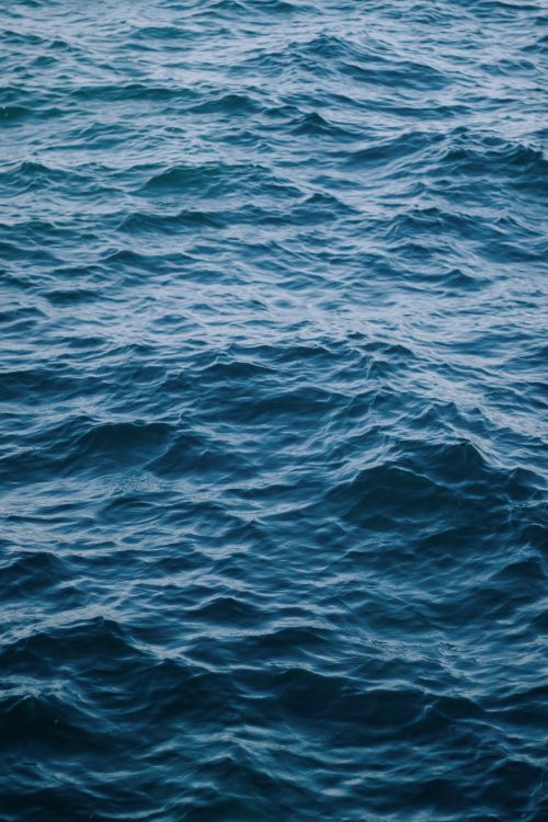Free Captivating view of gentle ocean ripples creating a calming pattern on a blue water surface. Stock Photo