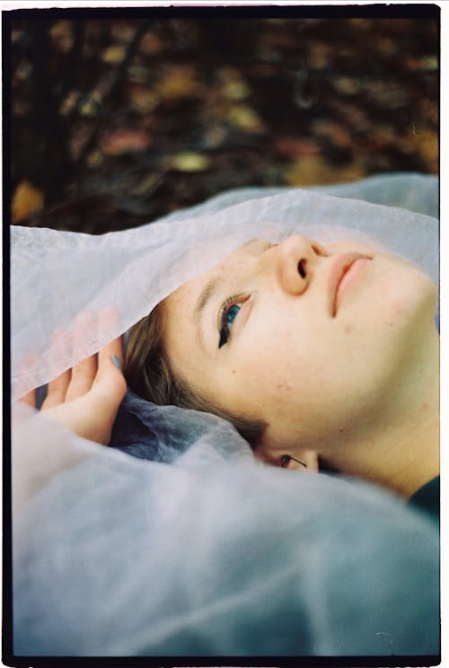 Free Woman Lying on White Textile Stock Photo