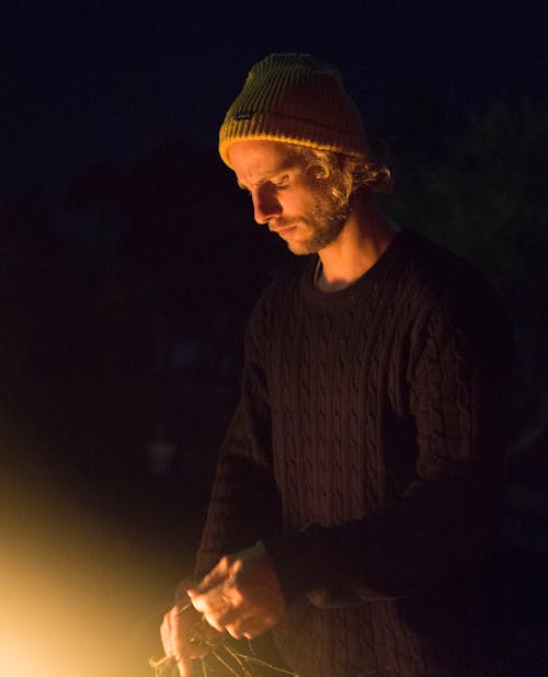 Man Wearing Black Sweater and Holding Rope