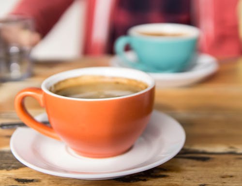 Free Shallow Focus Photo of Orange Ceramic Mug on White Saucer Stock Photo