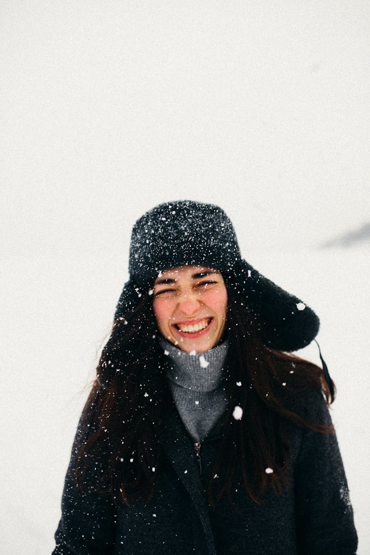Woman Smiling In Falling Snow