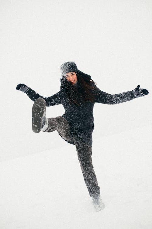 Woman Playing with Snow during Winter