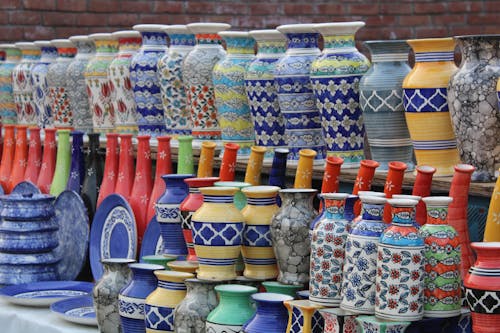 Assorted Color Ceramic Jars on Shelf