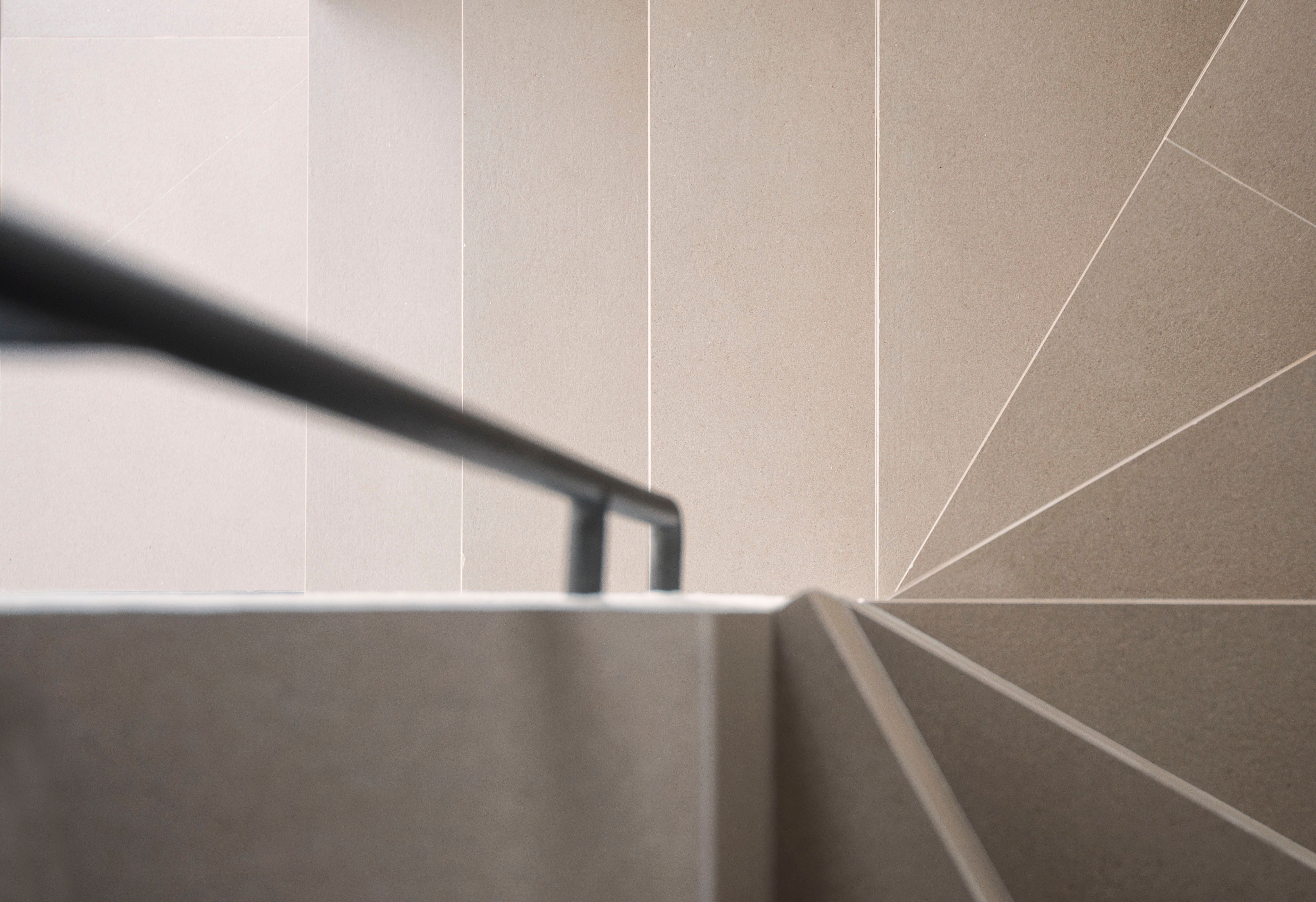 Minimalist staircase with geometric patterns and railing, ideal for contemporary designs.