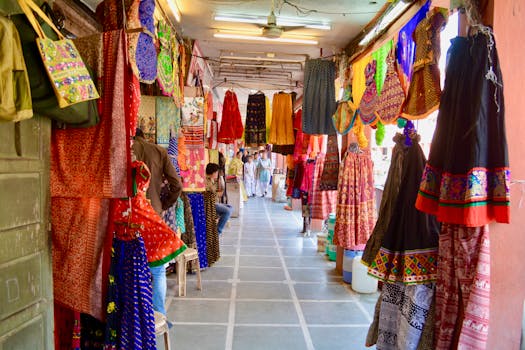 A vibrant display of traditional clothing and textiles at a market in Jaipur, India.