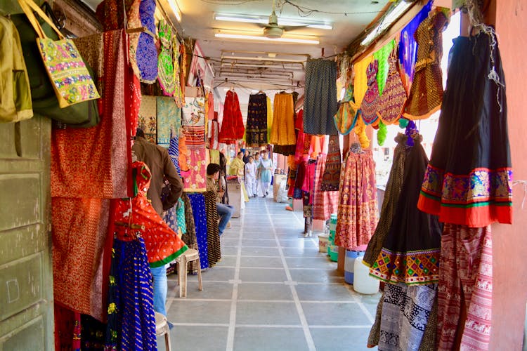 Assorted Clothes Hanged On The Market Place