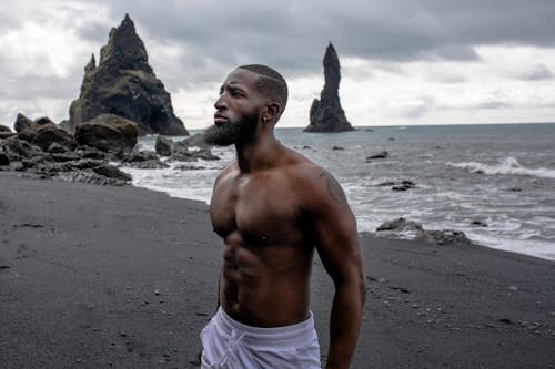 Man Wearing White Bottoms Near Body of Water