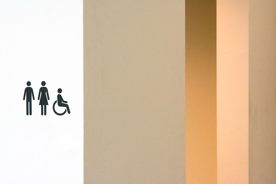 Restroom sign showing male, female and wheelchair symbols