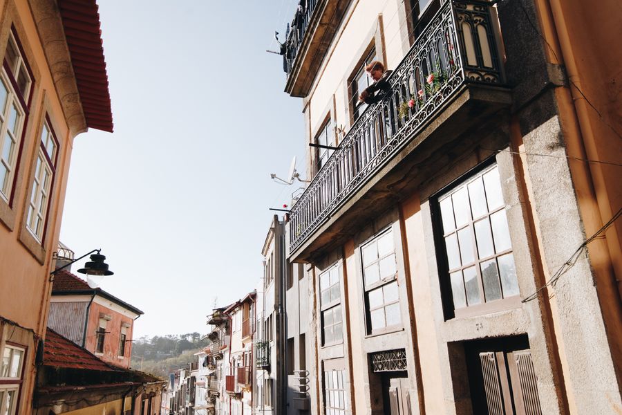 Narrow old-town street with tiled facades and iron balconies — Cátia Matos on Pexels
