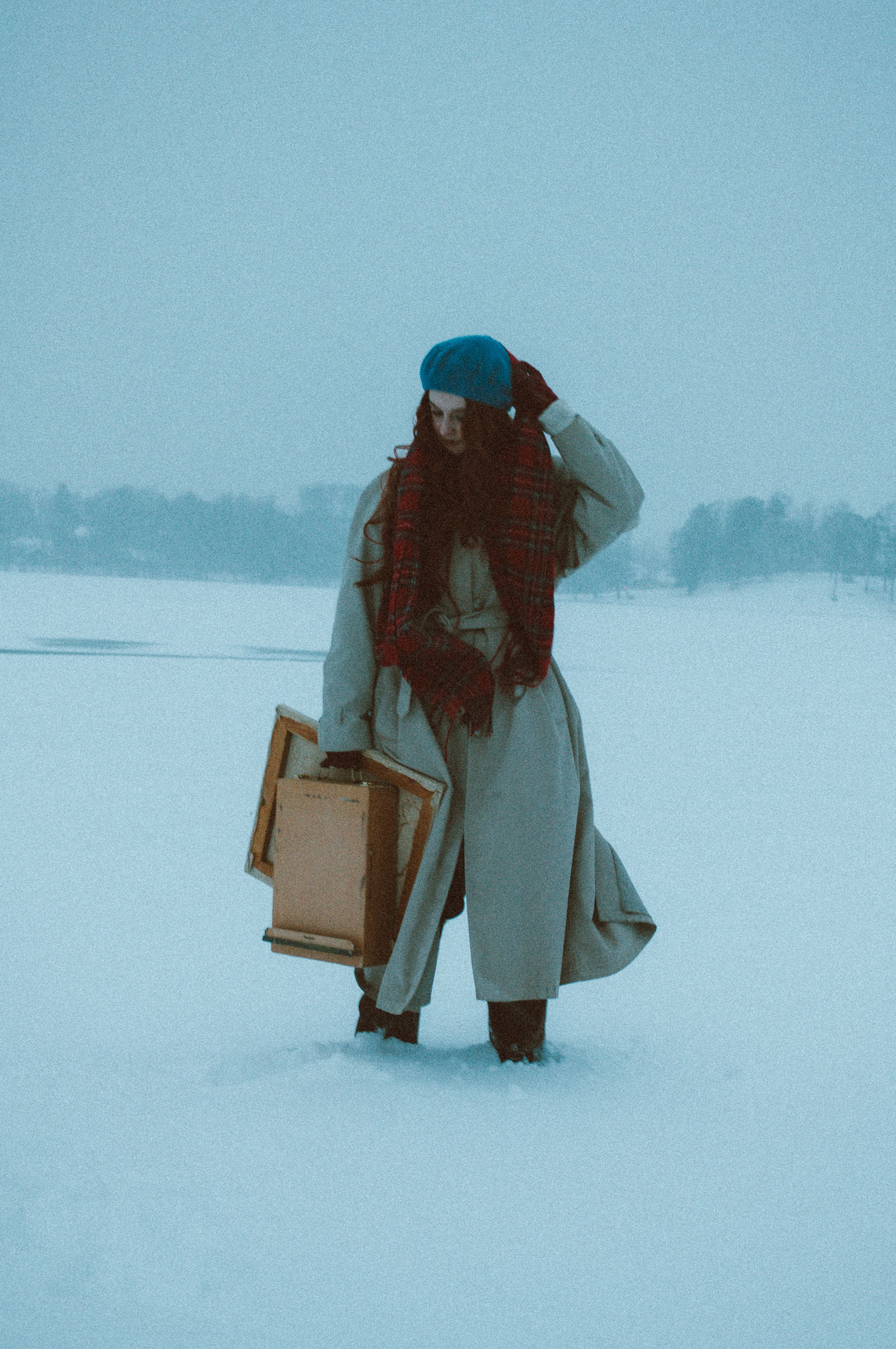 A Woman in White Coat Standing on a Snow-Covered Field · Free Stock Photo