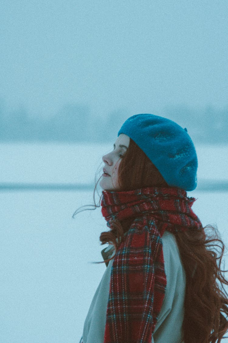 Woman With Long Hair In Scarf Standing In Snow