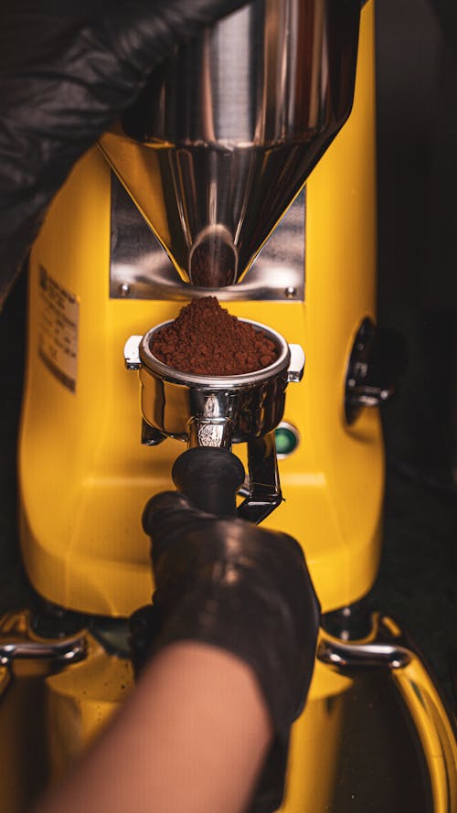 Close-Up Shot of a Person Grinding a Coffee