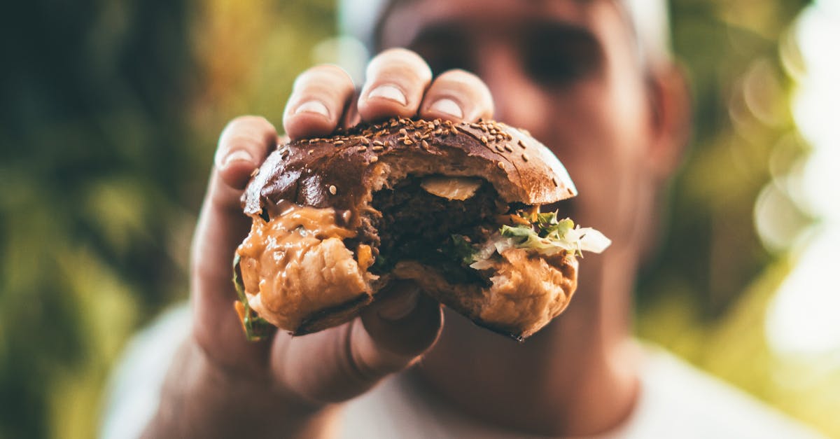 Photo of Person Holding Burger