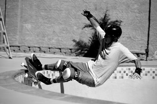 Free Grayscale Photo of a Man Doing Skateboard Trick Stock Photo