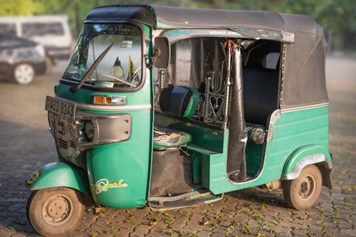 A Green Auto Rickshaw on the Road