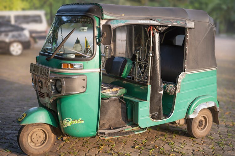 A Green Auto Rickshaw On The Road