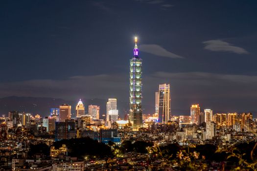 Breathtaking aerial view of Taipei city skyline at night with Taipei 101 illuminated.