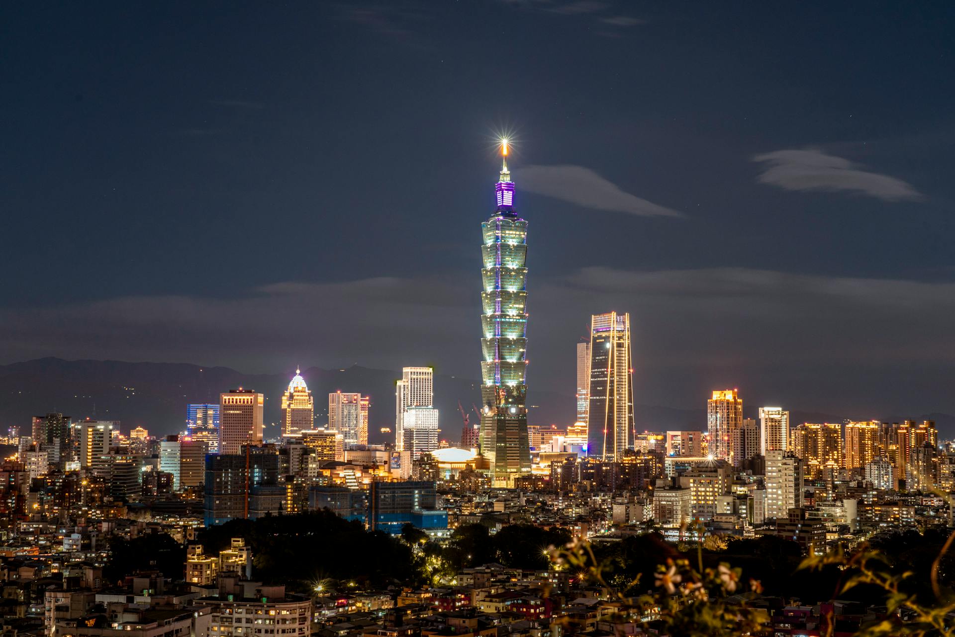 Breathtaking aerial view of Taipei city skyline at night with Taipei 101 illuminated.