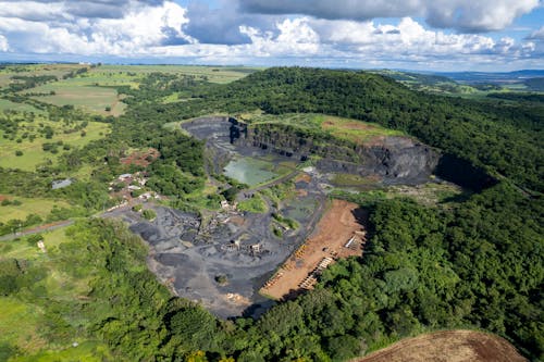 Aerial View of a Mine Surrounded by Green Fields and Trees