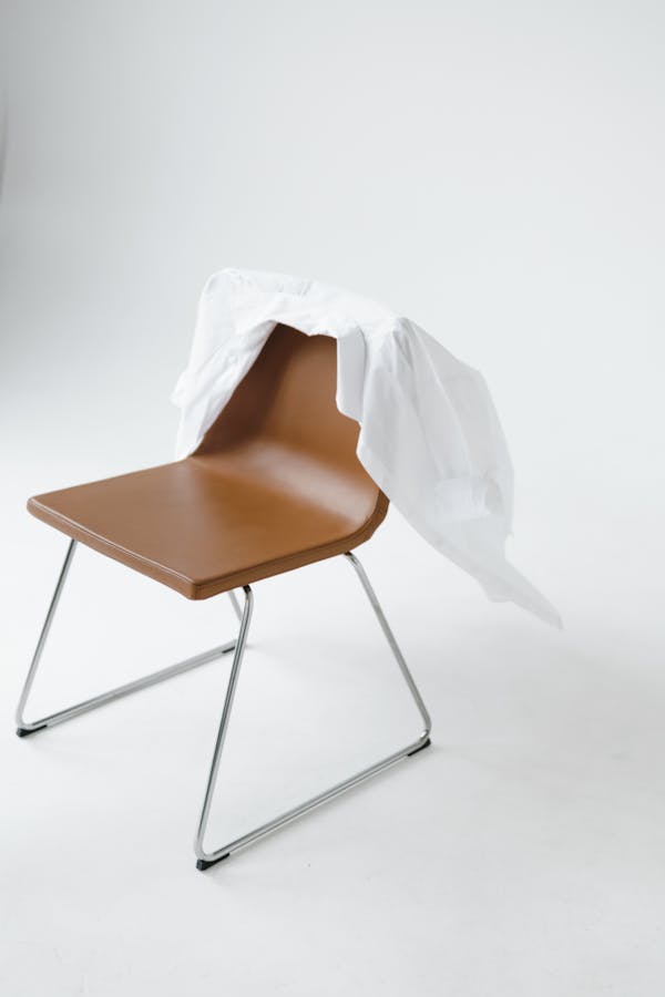 White Shirt on Draped on Back of Chair
