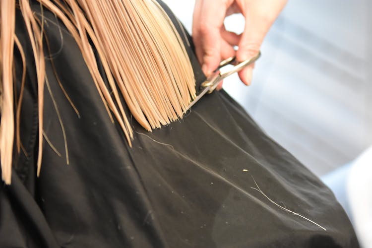 Close-up Of Woman Getting Her Hair Cut 