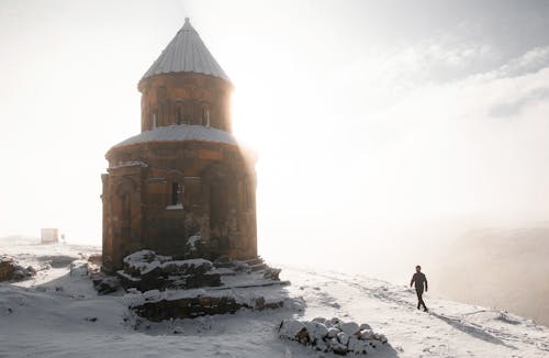 A Man Walking Towards a Building at the Ani Ruins