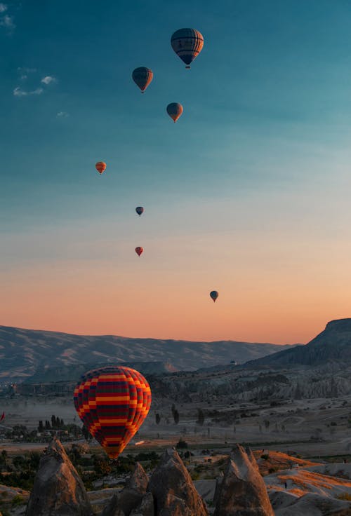 Hot Air Balloons Flying Over The Mountains