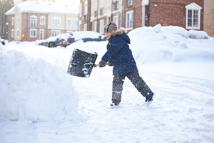 Kid Wearing Jacket Shoveling Snow