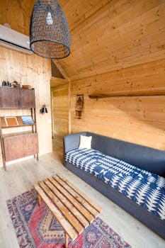Stylish wooden cabin interior with modern cozy decor and furniture.