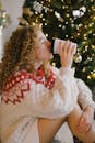 Woman in White Knit Sweater Drinking from Black Ceramic Mug