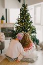 Woman in White Sweater Holding Green Christmas Tree