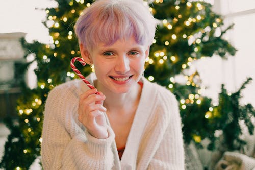 Woman with Colored Hair Holding a Candy Cane