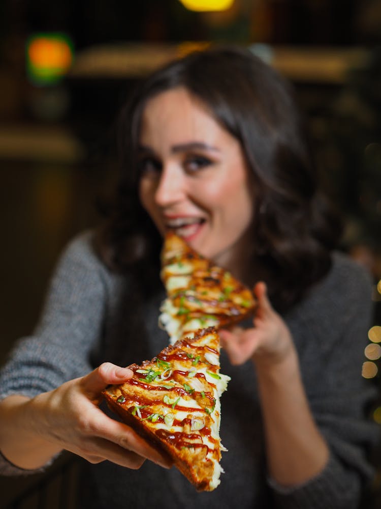 Woman Holding Slices Of Pizza 