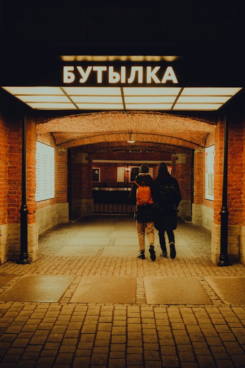 Back View of a Young Couple Walking into a Building 