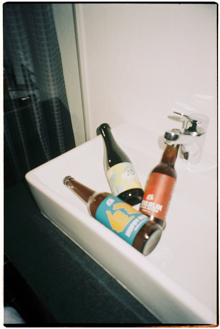 Close-Up Shot Of Bottles Of Liquors On The Sink