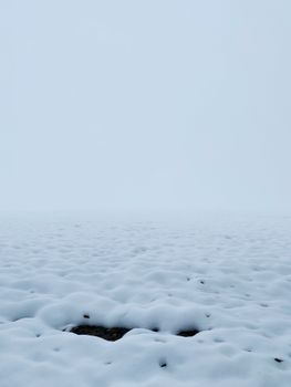 Peaceful snowy landscape with a frosty, frozen appearance, evoking winter tranquility.