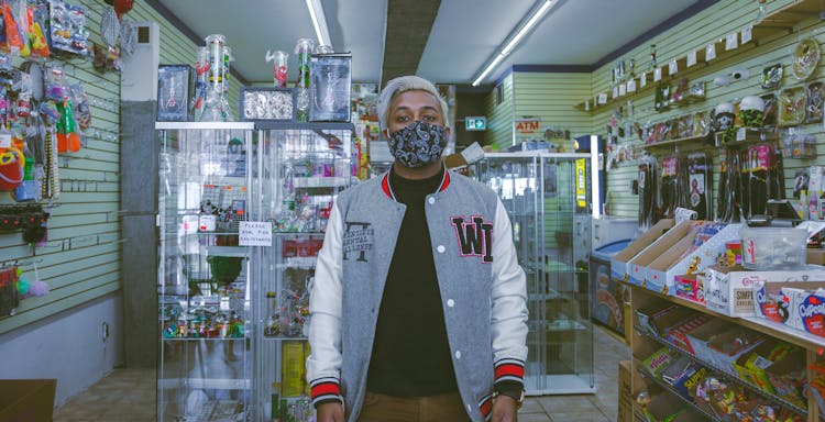 Man In Jacket With Face Mask In Store