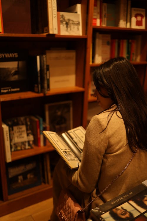 A Woman Reading a Book in the Library