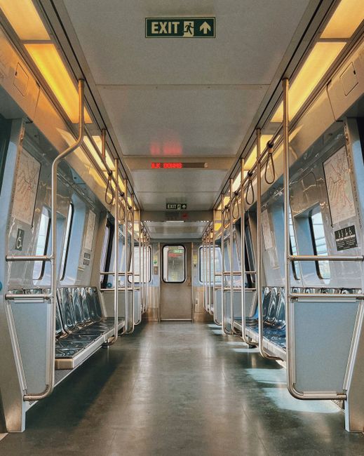 A modern and empty subway car interior in Boston, showcasing its sleek design and polished metal seats.