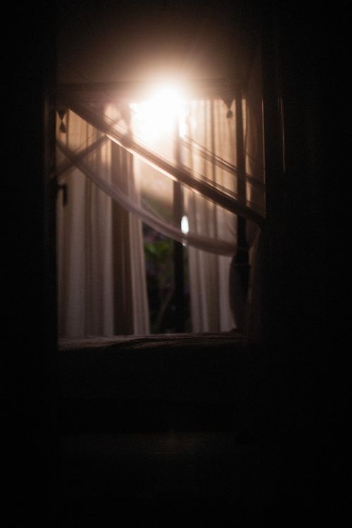 Free Cozy bedroom with sunlight filtering through curtains, creating a serene ambiance. Stock Photo