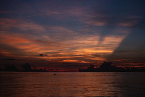 Free Stunning twilight ocean view with dramatic sky and shadows over the horizon. Stock Photo