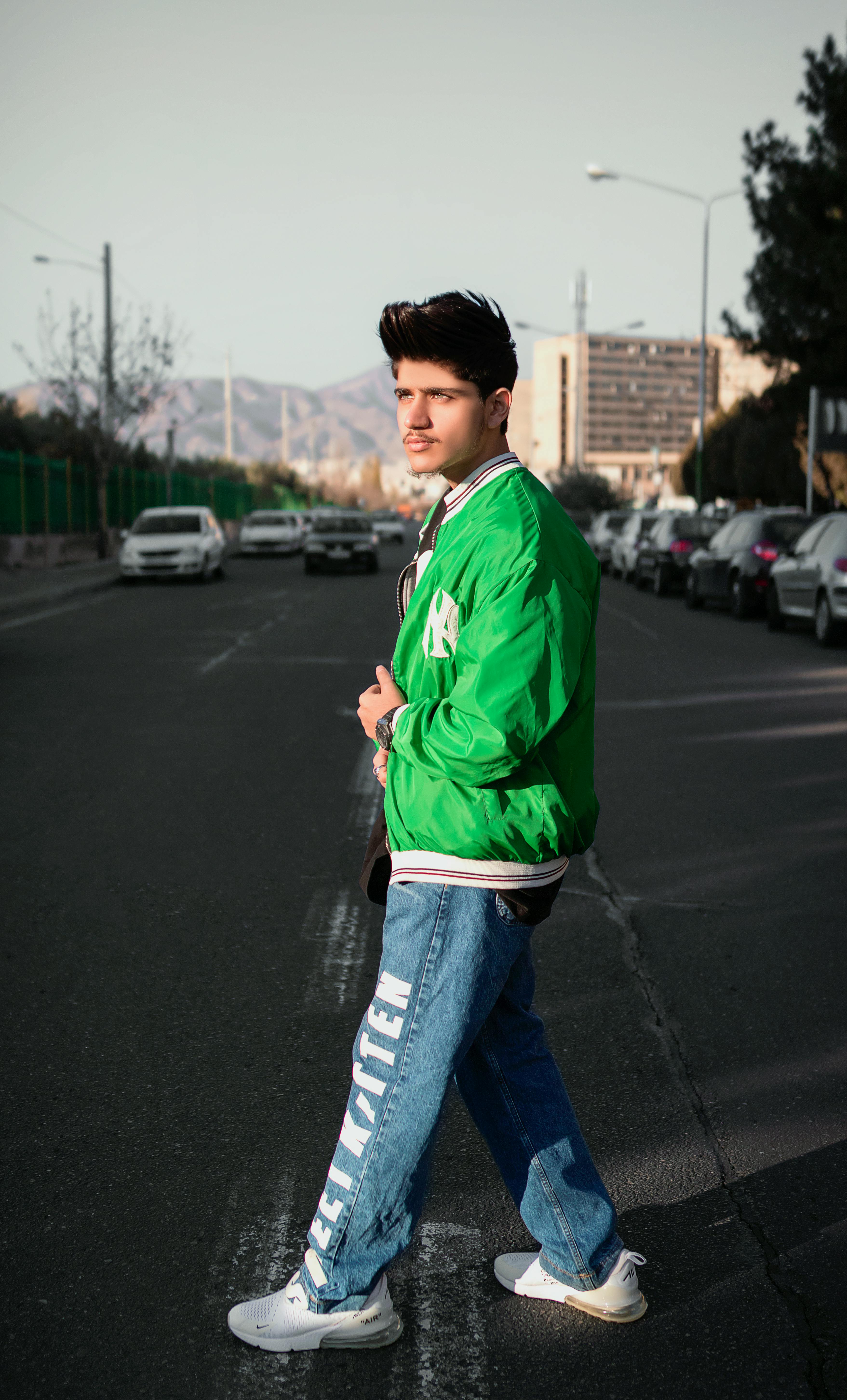 Man with Jacket on Shoulder Crossing Street · Free Stock Photo