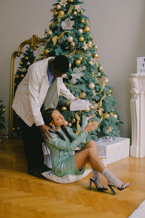 A Man Giving a Present to His Partner During Christmas